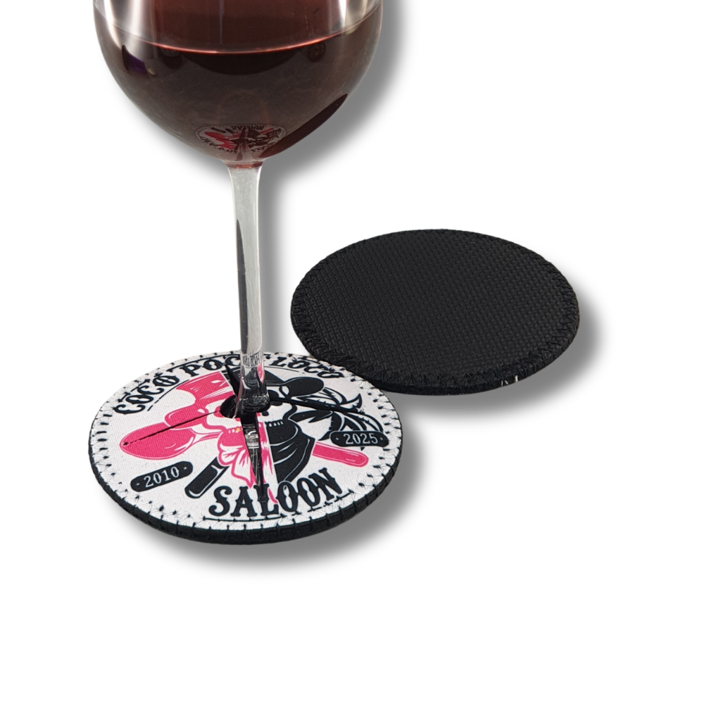 personalised-neoprene-wine-glass-shoe-coaster-saloon-anniversary Personalised neoprene wine glass shoe coaster with pink and black saloon anniversary design, fitted beneath a wine glass.
